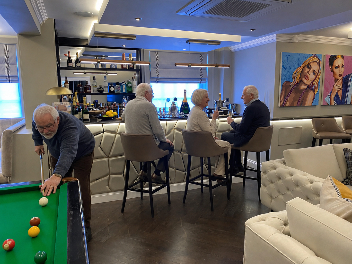 Guests at the bar and snooker table in The Village lounge